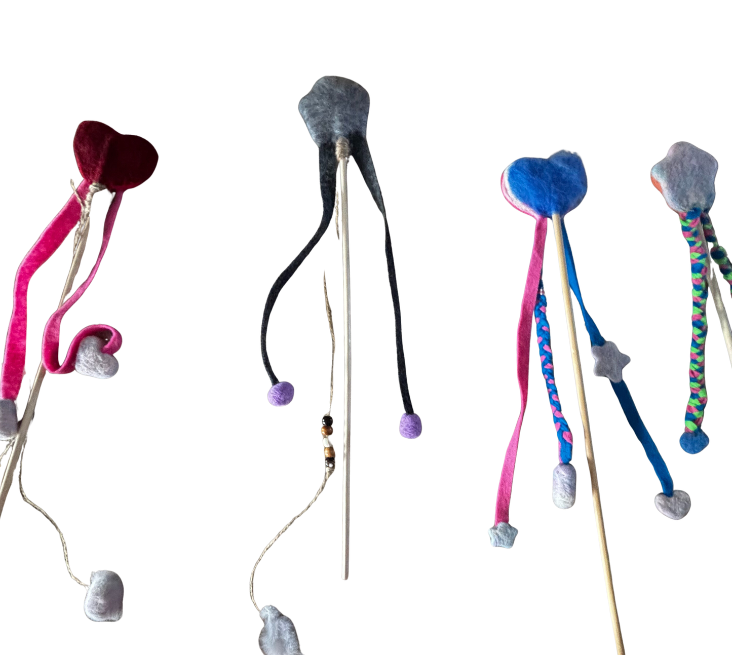Colorful cat toys with various shapes and materials on a white background